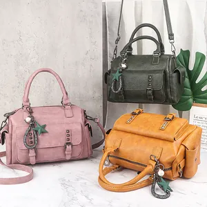 Three retro Boston handbags in pink, green and yellow with soft PU leather and star charms
