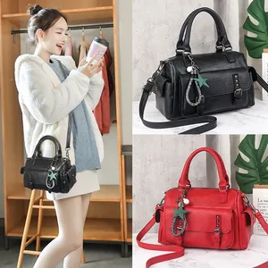 Classic Boston bag in textured lychee leather with star charm and adjustable strap