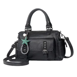 Classic black pebbled leather Boston handbag with star charm and detachable strap