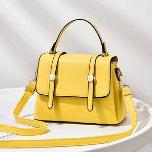 Bright yellow fashion crossbody bag with top handle and gold-tone metal hardware
