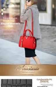 Close-up of red crocodile texture PU leather handbag with gold V logo and tassel detail