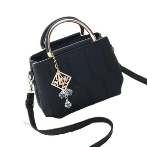 Elegant black faux leather crossbody bag with geometric stitching and gold handle