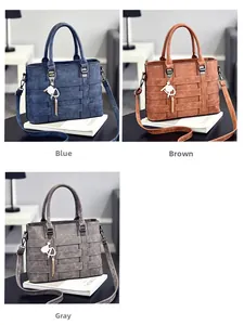 Three vintage leather handbags in blue, ochre, and gray with retro layered belt design