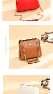 Detail view of bow clasp and wavy edge on fashion chain bags in red, brown, and white