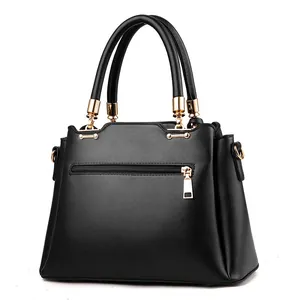 Chic black PU leather tote bag with gold hardware and back zipper shown on white background