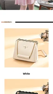 Detail of white leather shoulder bag with bow buckle and wavy edge on warm background