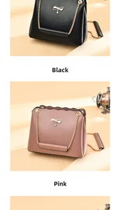 Detail view of stylish small square bags in black and pink with golden bow hardware