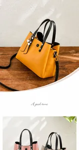 Close-up of yellow PU leather handbag featuring silver heart charm and black handles