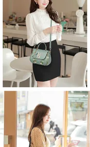 Detail of light green crossbody bag featuring floral embroidery and pearl butterfly charm