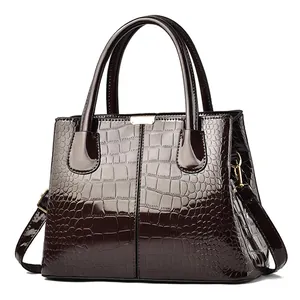 Glossy crocodile embossed dark brown leather handbag with gold hardware for women