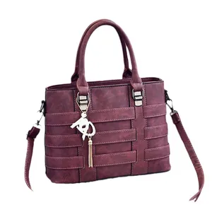 Deep purple faux leather tote bag with stylish gold hardware and hanging tassel