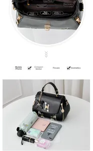 Detail view of the black embroidered handbag showing multiple interior storage compartments