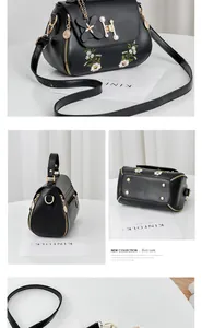 Detail view of black daisy embroidery bag with pearl H-buckle and bottom rivets