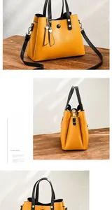 Detail view of yellow PU leather tote with black straps and heart metal pendant charm