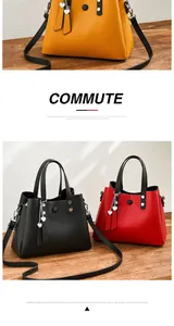 Detail of PU leather tote bags in yellow, black, and red with heart tassel charms