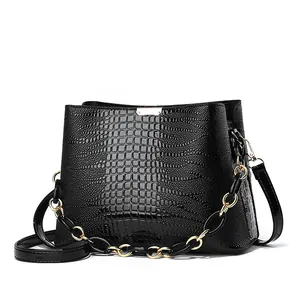 Elegant black embossed bucket bag with gold chain strap and top handle for women