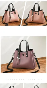 Detail view of stylish multi-pocket PU leather handbags with heart chain accessories
