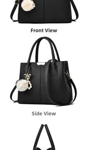 Détail du sac à main en cuir grainé noir avec pompon et breloque dorée