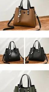 Close-up of soft PU leather handbags with heart pendants in brown, black and green