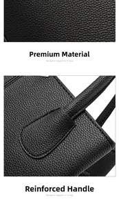 Détail du sac à main en cuir noir grainé avec poignée renforcée et coutures de précision