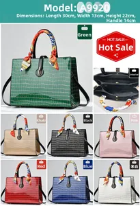 Detail of embossed crocodile pattern handbag with dimensions and silk scarf handle