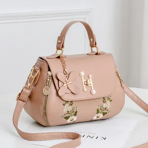 Chic pink embroidered PU leather handbag with floral patterns and pearl H-clasp detail