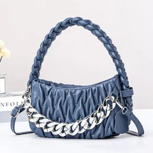 Modern light blue pleated woven handbag with chunky silver chain and crossbody strap