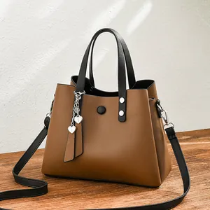 Fashionable brown PU leather tote bag with black handles and heart charm details
