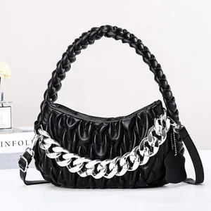 Black matelassé woven handbag with chunky silver chain and adjustable shoulder strap