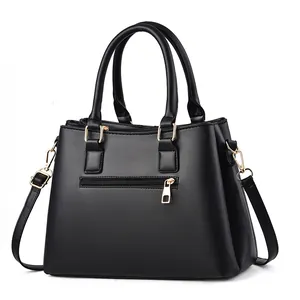 Classic black faux leather tote bag with gold hardware and front zipper pocket