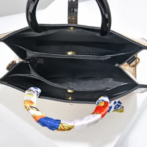 Interior view of crocodile pattern handbag with multi-compartment storage and silk scarf