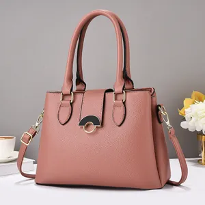 Detail of rose pink tote bag featuring lychee texture leather and gold metal buckle