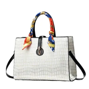 Classic cream embossed crocodile pattern handbag with black handles and printed silk scarf
