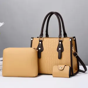 Three-piece women bag set featuring yellow crocodile embossed pattern and brown handles