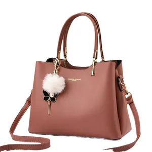 Pink faux leather tote bag for women with pompom charm and adjustable shoulder strap