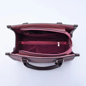 Detailed interior of crocodile textured tote bag with multiple storage compartments