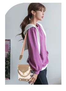 Quilted crossbody phone bag with colorblock design and wide shoulder strap on model