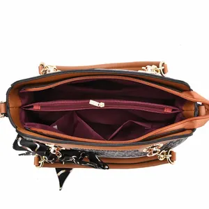 Top view showing three large interior compartments with burgundy lining and a zipper pocket