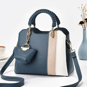 Detailansicht der blauen Tasche mit gewebtem Griff, Lederstruktur und kleinem Geldbeutel