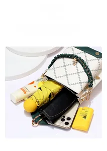 Top view of compact crossbody phone bag showing large capacity with daily essentials