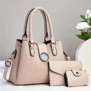 Detailed view of 3-piece bag set with woven embossed texture and silver metal rivets