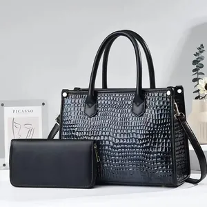 Detail of black faux leather tote with crocodile texture and matching long wallet