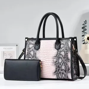 Detail of snake skin texture tote bag and matching long wallet set with gold hardware