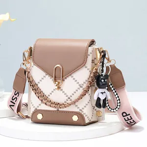 Chic quilted cream phone bag with brown accents and wide lettered shoulder strap