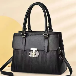Elegant black embossed striped handbag with golden letter clasp and shoulder strap