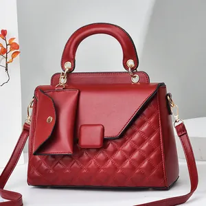 Dettaglio borsa trapuntata rosso vino con mini portamonete rimovibile e minuterie dorate