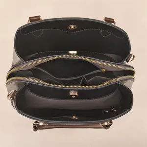 Top view of spacious interior featuring three compartments and rose gold metal hardware