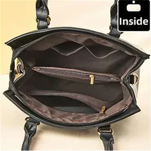 Detailed interior view of a black tote bag showing spacious compartments and golden zipper