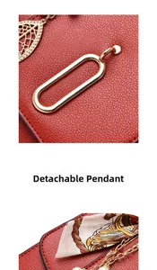 Macro detail of red litchi texture leather with gold leaf charm and silk scarf accessory