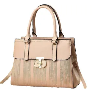 Elegant beige tote bag with wavy embossed texture and gold metal clasp on white background